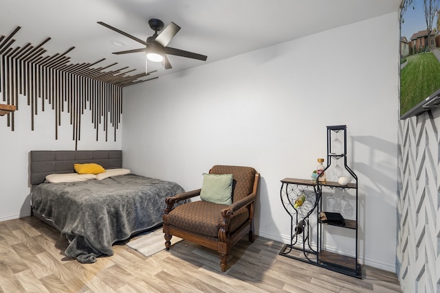 bedroom with ceiling fan and light hardwood / wood-style floors