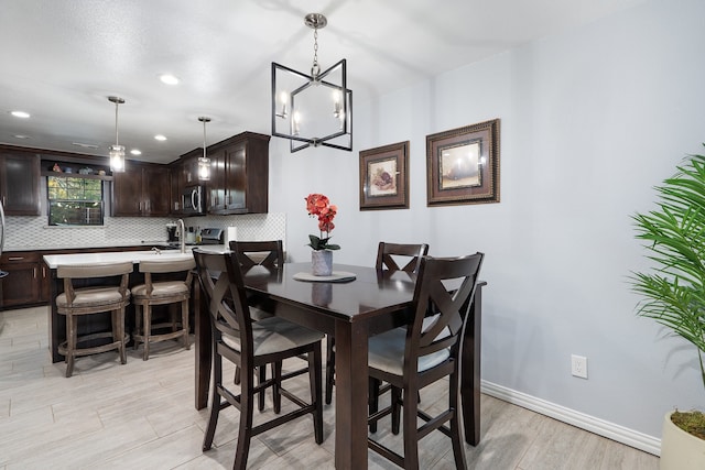 dining room featuring light hardwood / wood-style flooring and an inviting chandelier