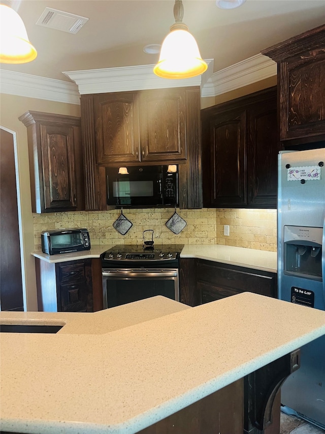 kitchen with decorative light fixtures, dark brown cabinetry, backsplash, and appliances with stainless steel finishes