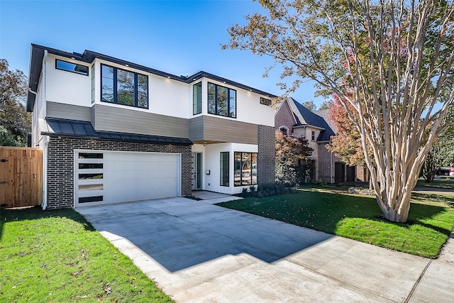 view of front of property with a front yard and a garage