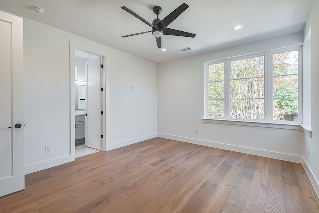 unfurnished room with ceiling fan and light wood-type flooring