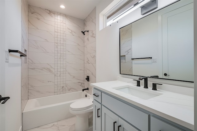 full bathroom with toilet, vanity, and tiled shower / bath