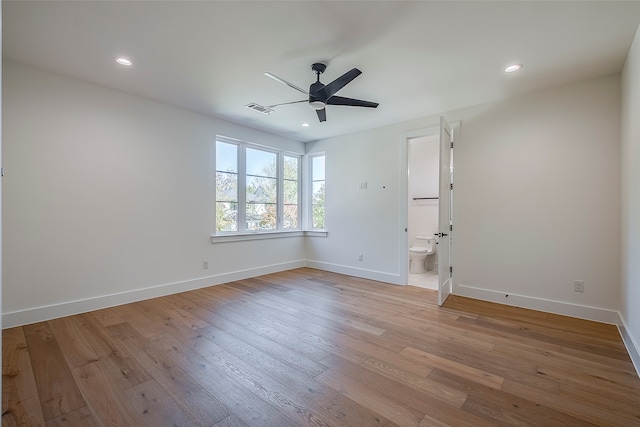 spare room with ceiling fan and light wood-type flooring