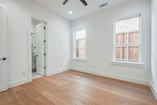 unfurnished room featuring ceiling fan, a healthy amount of sunlight, and light wood-type flooring