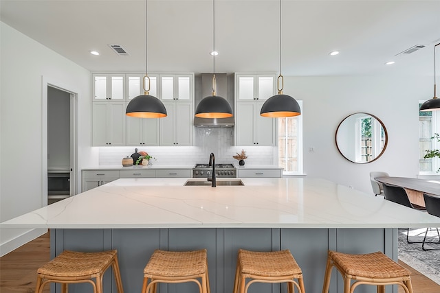 kitchen with premium range hood, light stone countertops, tasteful backsplash, and dark wood-type flooring