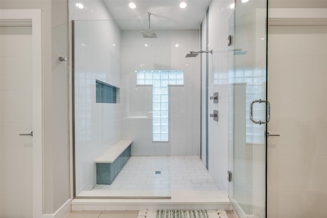 bathroom featuring a shower with shower door