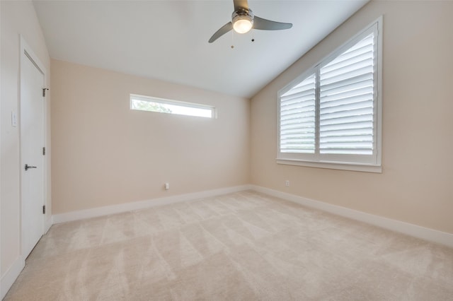 carpeted empty room with vaulted ceiling and ceiling fan