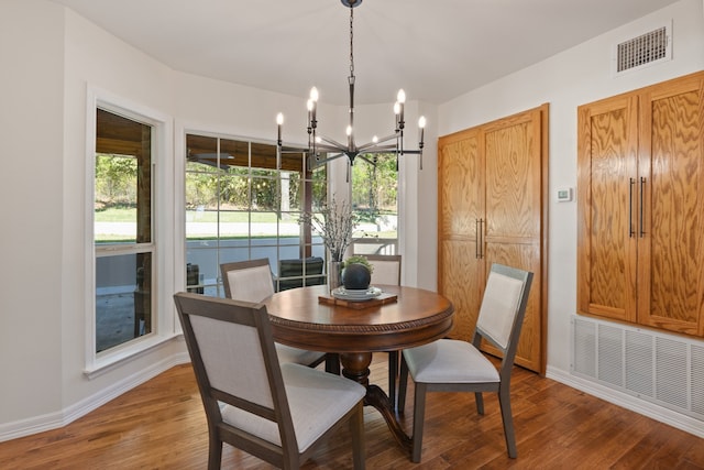 dining room featuring hardwood / wood-style flooring and a chandelier