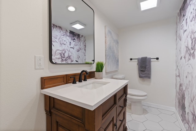 bathroom featuring tile patterned flooring, vanity, and toilet