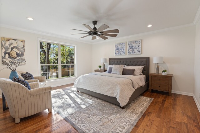 bedroom featuring ceiling fan, dark hardwood / wood-style flooring, and ornamental molding