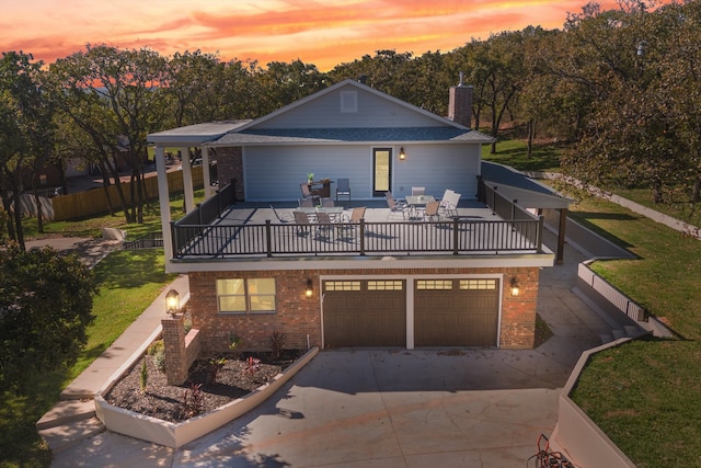 view of front of home with a yard and a garage