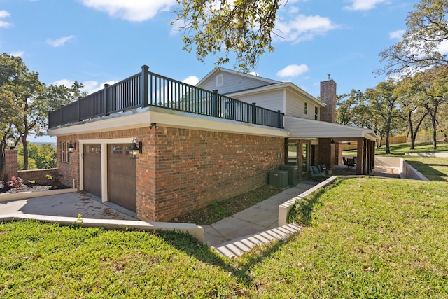 view of property exterior featuring central air condition unit, a balcony, a garage, and a lawn