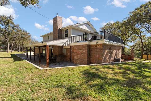 rear view of house featuring a patio area, a yard, and central AC unit