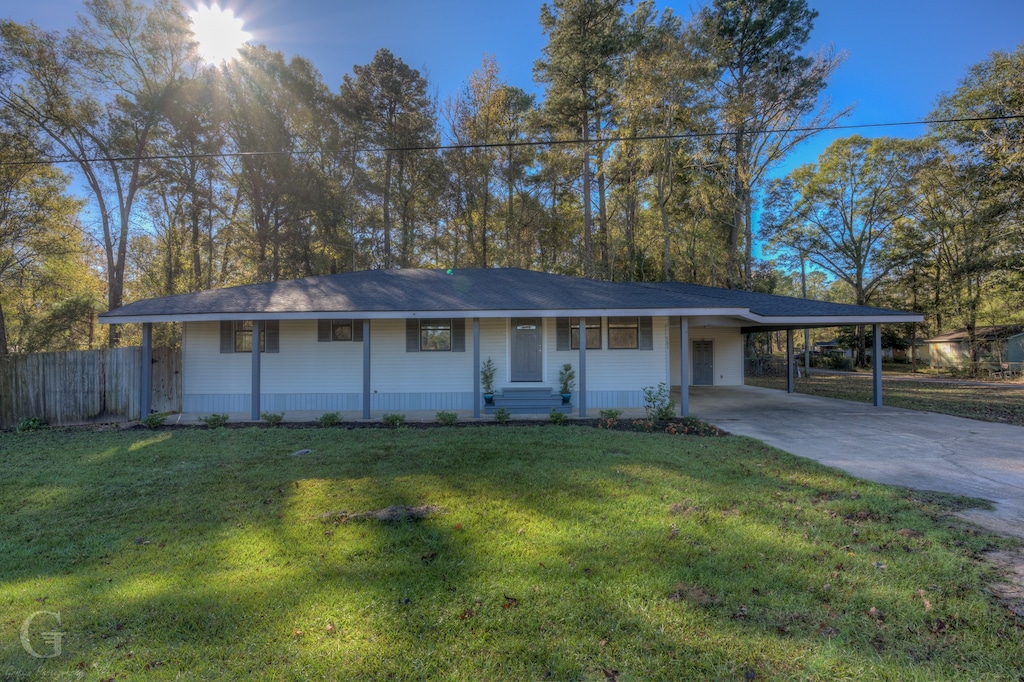 single story home featuring a front yard and a carport