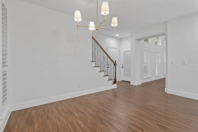 interior space featuring a notable chandelier and dark wood-type flooring