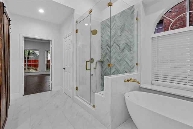 bathroom with hardwood / wood-style floors, independent shower and bath, and tile walls