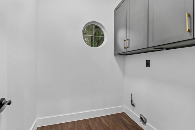 laundry room with cabinets, dark wood-type flooring, and hookup for an electric dryer