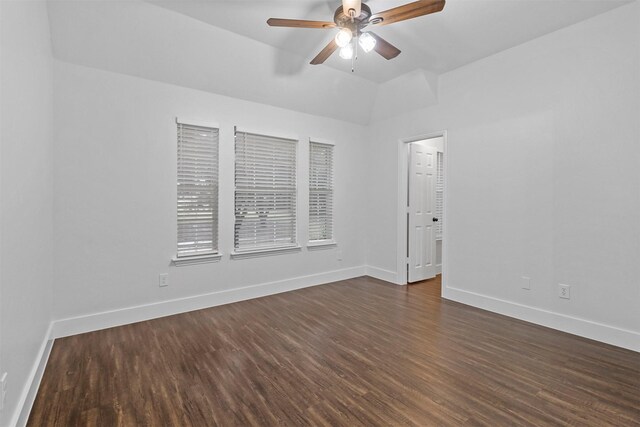 unfurnished room with dark hardwood / wood-style floors, ceiling fan, and vaulted ceiling