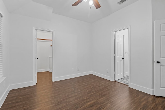 empty room with ceiling fan and dark hardwood / wood-style floors