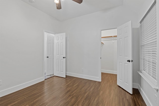 unfurnished bedroom featuring ceiling fan, dark hardwood / wood-style flooring, and a closet