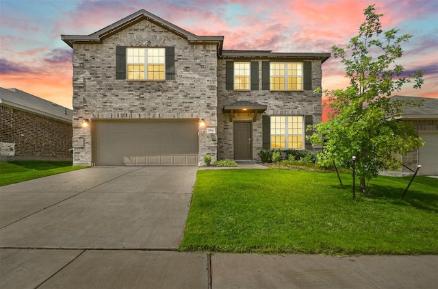 view of front of property featuring a lawn and a garage