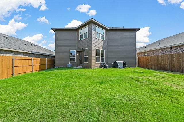 back of house featuring a lawn