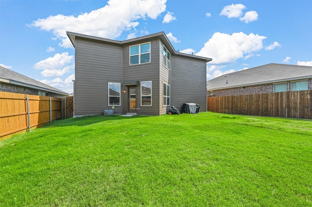 rear view of property featuring a lawn