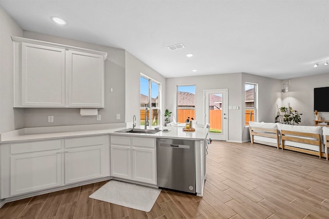 kitchen featuring white cabinetry, dishwasher, sink, and light wood-type flooring