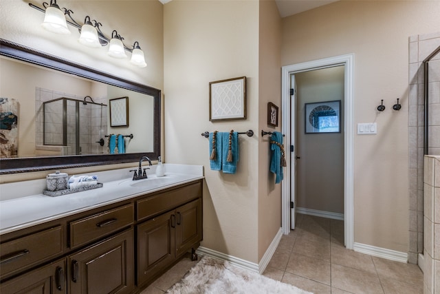 bathroom featuring tile patterned floors, vanity, and a shower with shower door