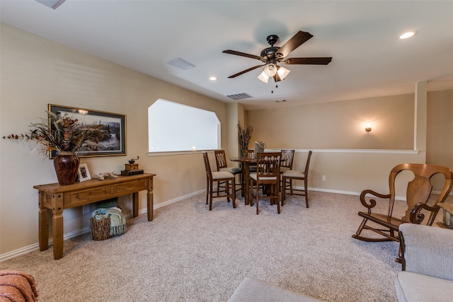 carpeted dining room featuring ceiling fan