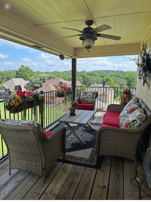 wooden terrace featuring ceiling fan