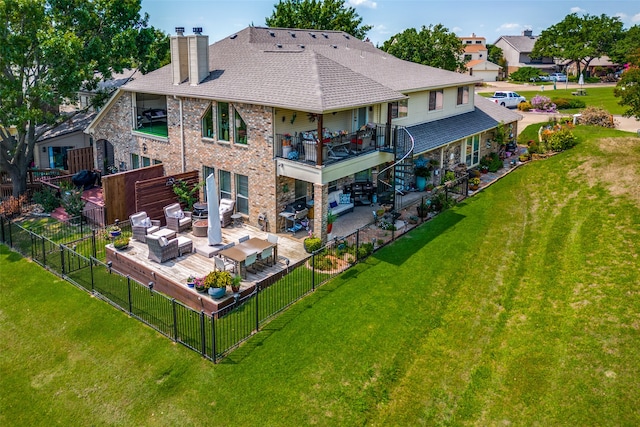 back of house with a yard, a balcony, a patio, and an outdoor hangout area