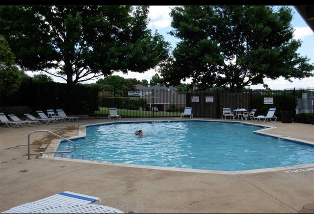 view of swimming pool with a patio area