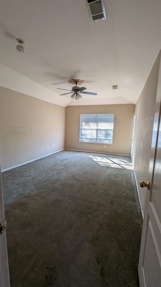 carpeted spare room with ceiling fan and lofted ceiling