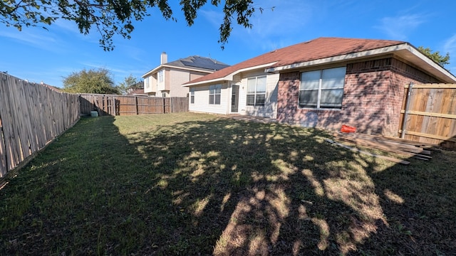 back of property with a lawn