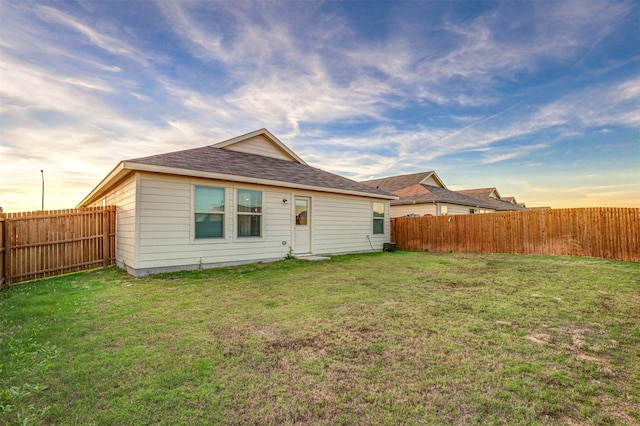 back of house featuring a yard