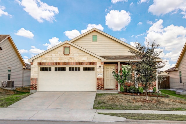 view of front of home with a garage and central AC unit