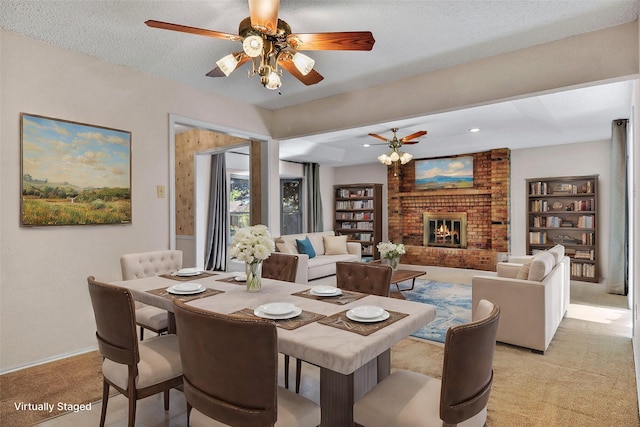 carpeted dining space with a fireplace and a textured ceiling