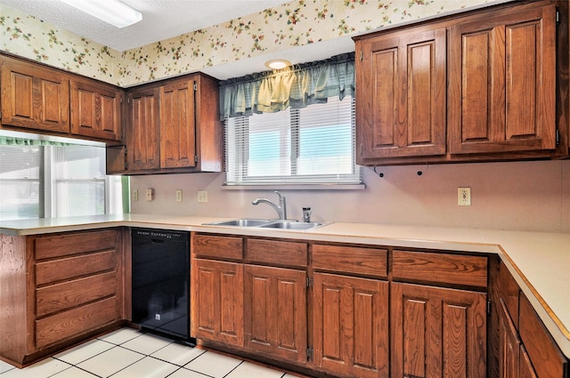 kitchen featuring light tile patterned flooring, a textured ceiling, black dishwasher, and sink