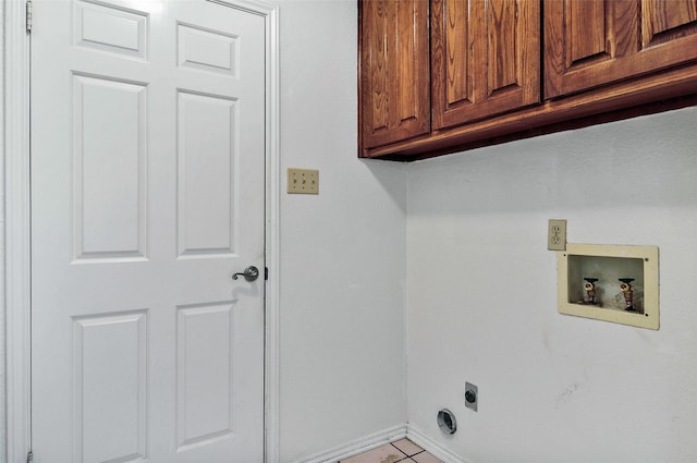 laundry room featuring hookup for a washing machine, light tile patterned floors, cabinets, and hookup for an electric dryer