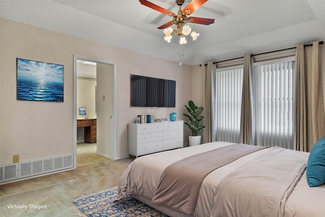 bedroom with ensuite bath, ceiling fan, light carpet, and a textured ceiling