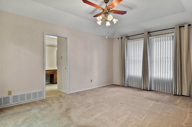 carpeted spare room featuring a textured ceiling and ceiling fan