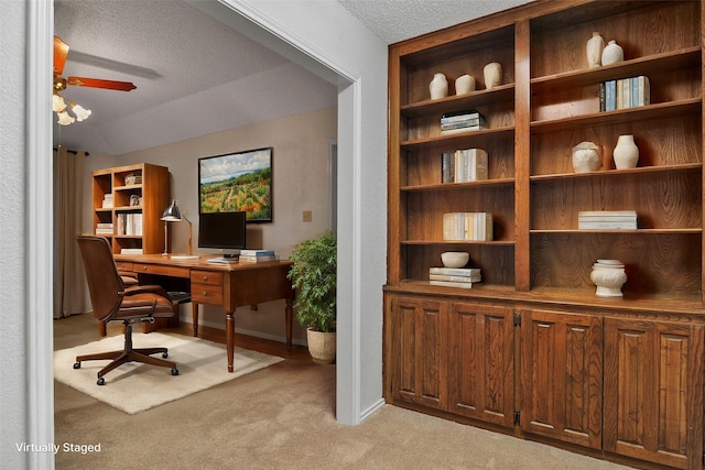 carpeted home office featuring ceiling fan and a textured ceiling