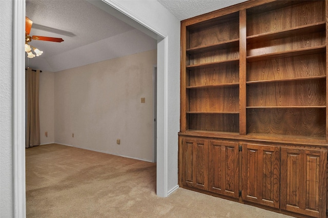 interior space with a textured ceiling and ceiling fan