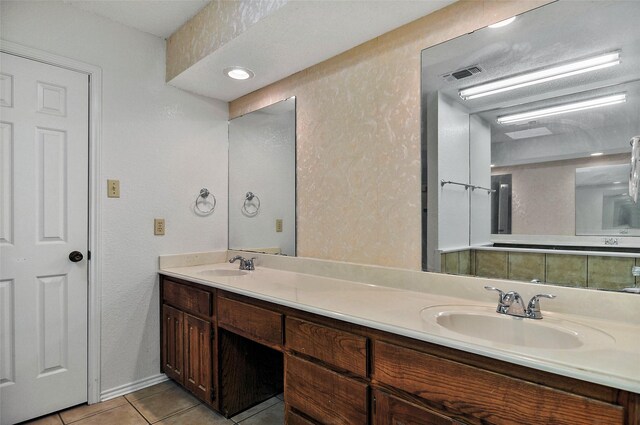 bathroom featuring tile patterned flooring and vanity