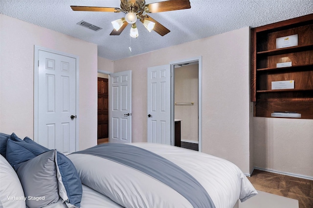 bedroom featuring a textured ceiling, ceiling fan, and dark wood-type flooring