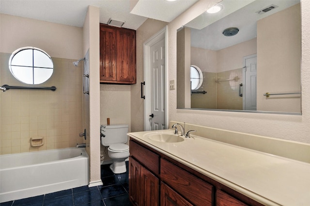 full bathroom featuring tile patterned flooring, plenty of natural light, toilet, and tiled shower / bath