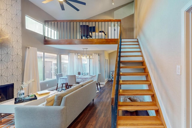 living room with ceiling fan, dark wood-type flooring, and a tile fireplace