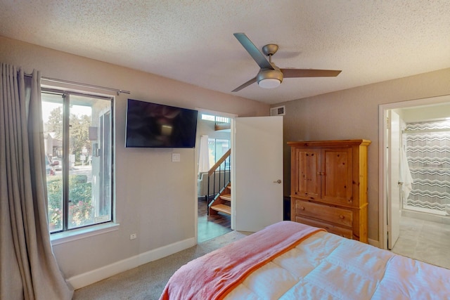 bedroom featuring connected bathroom, ceiling fan, and multiple windows