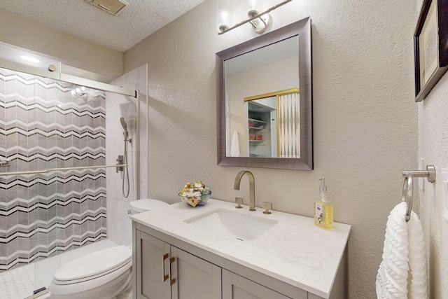 bathroom with vanity, curtained shower, toilet, and a textured ceiling